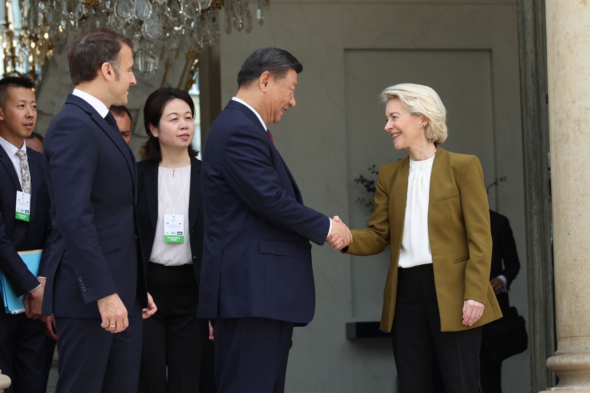 French President Emmanuel Macron (L), European Commission President Ursula von der Leyen (R), and China's President Xi Jinping (C) leave after attending a meeting at the Elysee presidential palace.