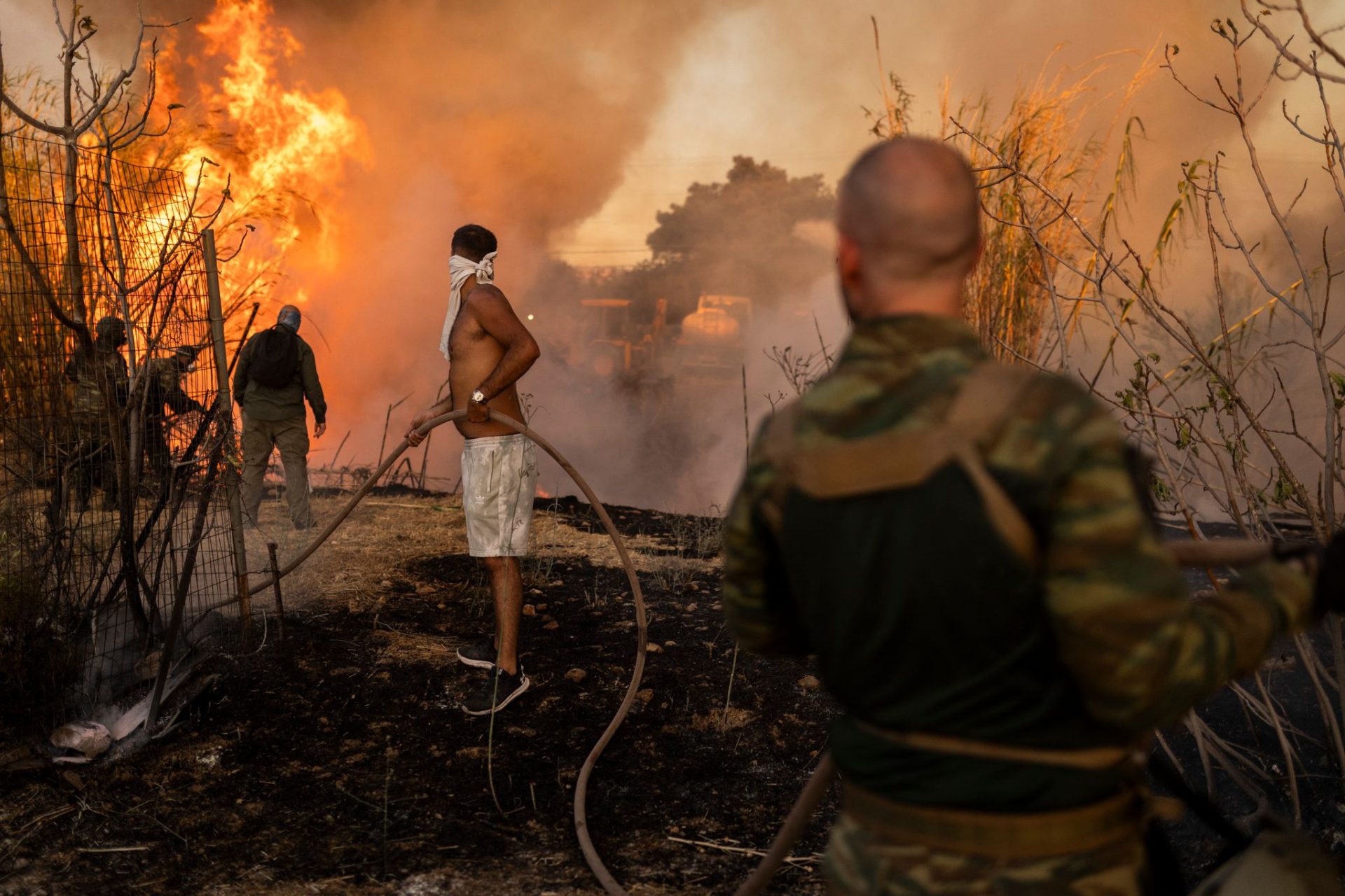 Volunteers extinguish a forest fire in Ano Patima near Penteli in the northern Athens region. EU member states are sending aid to Greece to help emergency services in battling the country's biggest wildfire of the year on Monday, with multiple flash points burning across some 200 square kilometres of woodland north-east of the capital Athens.