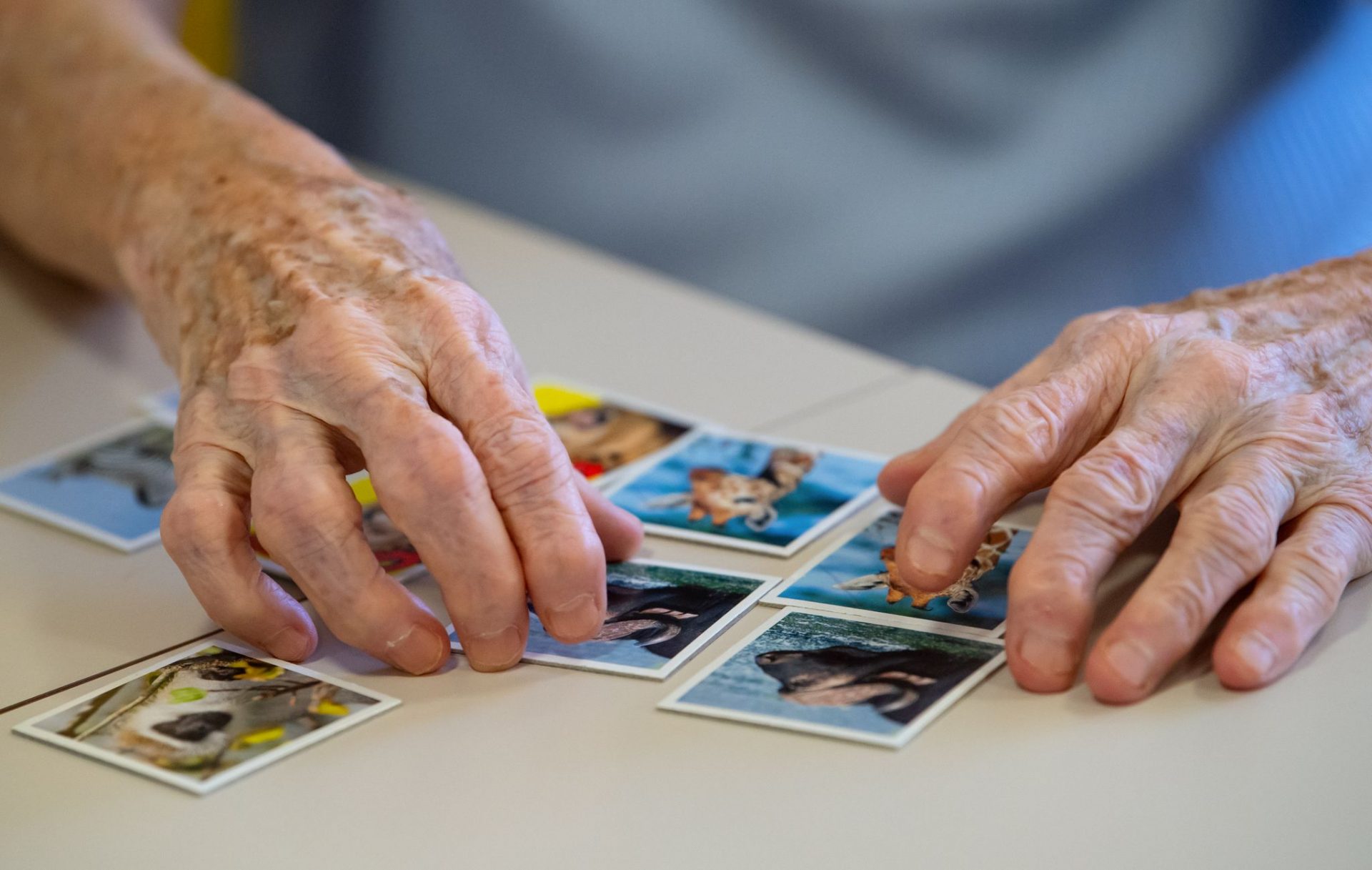 A resident of a nursing home plays the game "Memory" on a care ward and puts pairs of cards together. The European Union's drugs regulator reversed its decision to block the Alzheimer's drug lecanemab, a treatment aimed at slowing cognitive decline in patients.