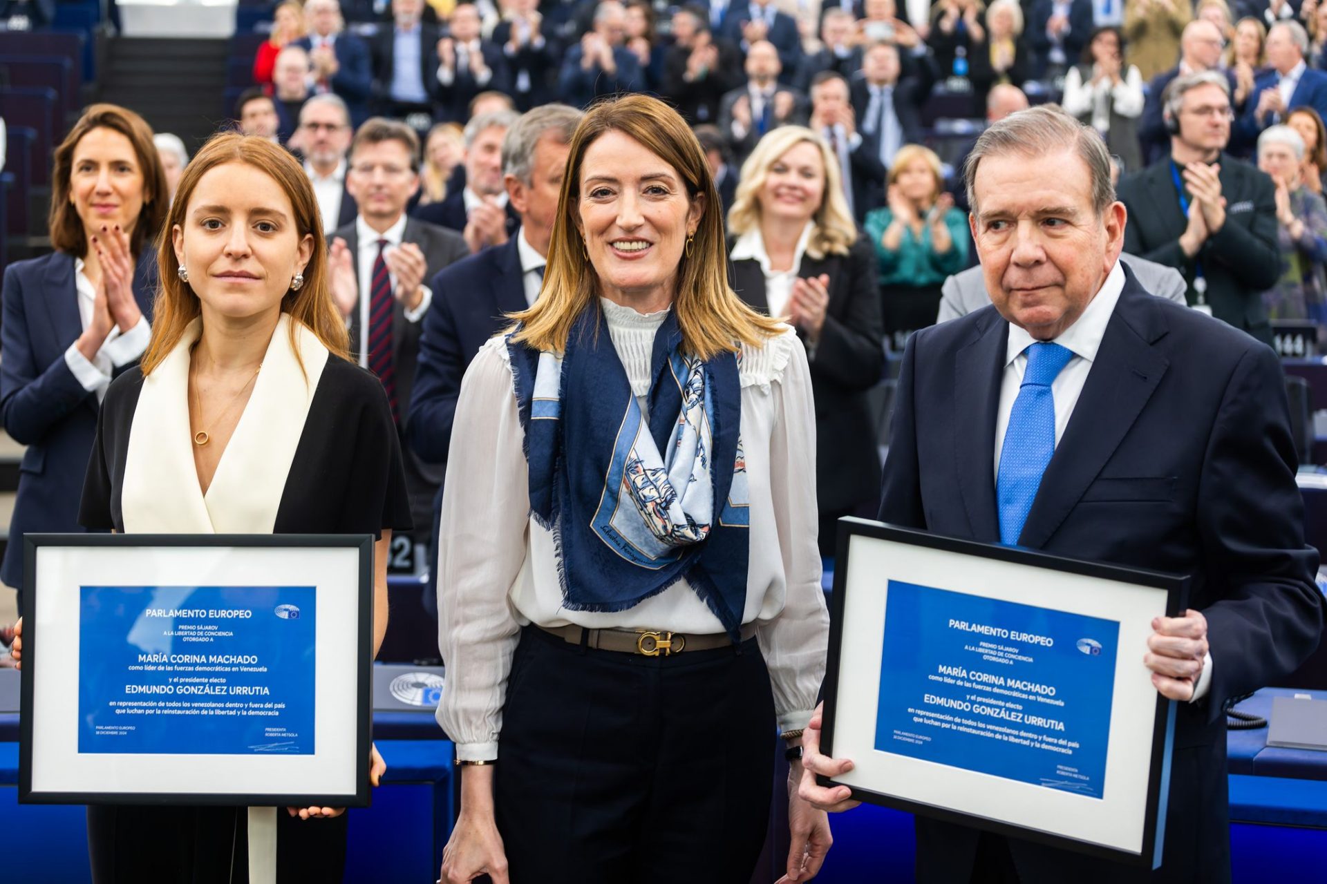 Sakharov Prize winner Edmundo Gonzalez Urrutia (R), European Parliament President Roberta Metsola (C) and Ana Corina Sosa, daughter of Sakharov Prize winner M. C. Machado, who was not present in person, react during the Plenary session of the European Parliament in Strassbourg. The Venezuelan opposition has been awarded the Sakharov Prize on the second day of December's plenary session.