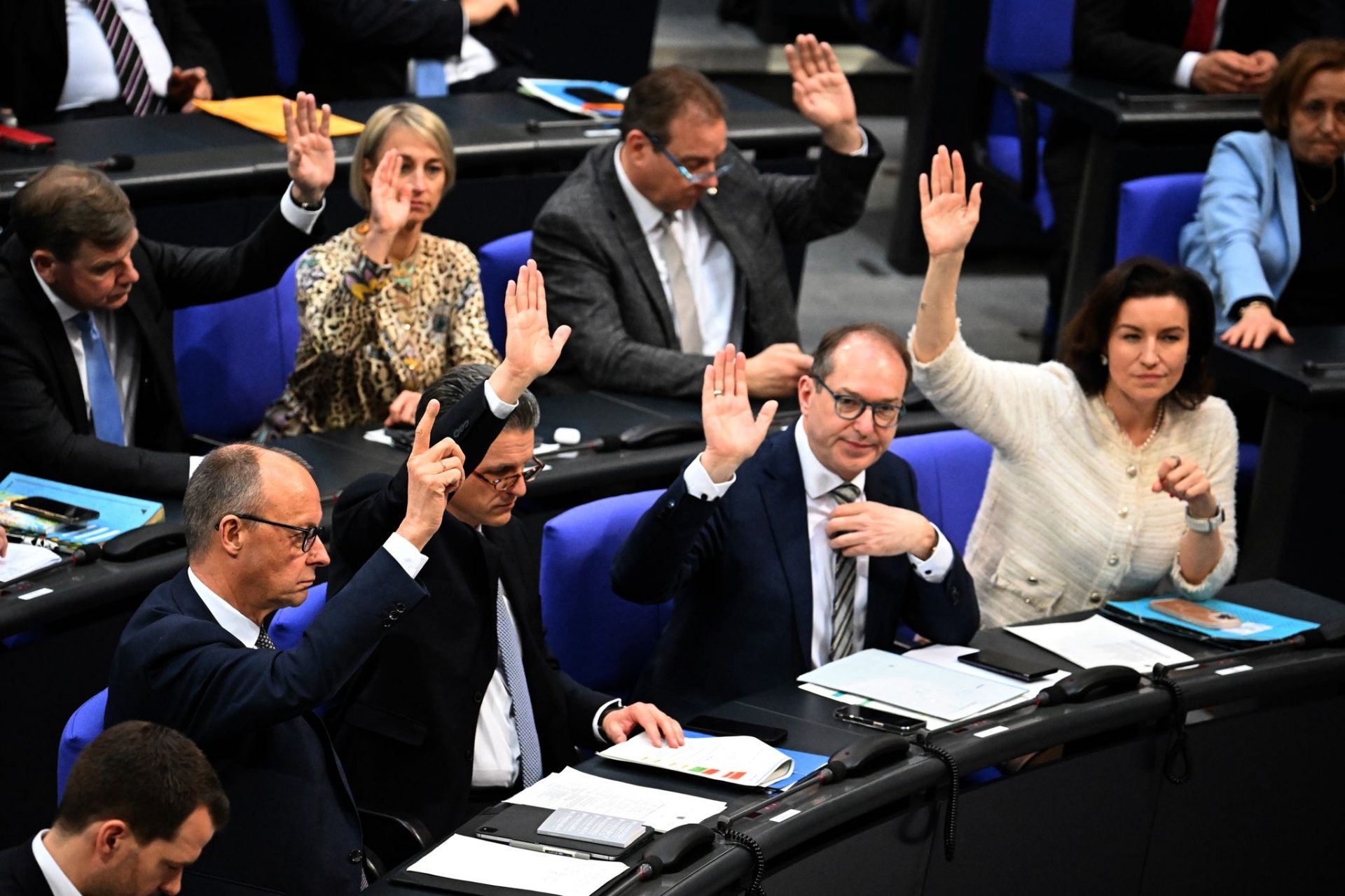 (L-R) Friedrich Merz, leader of the the Christian Democratic Union of Germany (CDU)/Christian Social Union in Bavaria (CSU) Parliamentary group, and Thorsten Frei, First Parliamentary Secretary of the CDU/CSU parliamentary group, vote on the first motion for a resolution in the 214th plenary session of the 20th legislative period in the German Parliament (Bundestag). Lawmakers in Germany's lower house of parliament, the Bundestag, are set to vote on Tuesday on a highly debated €500 billion ($547 billion) spending package, aimed at revitalizing infrastructure and advancing climate initiatives, as well as measures to boost defence spending.