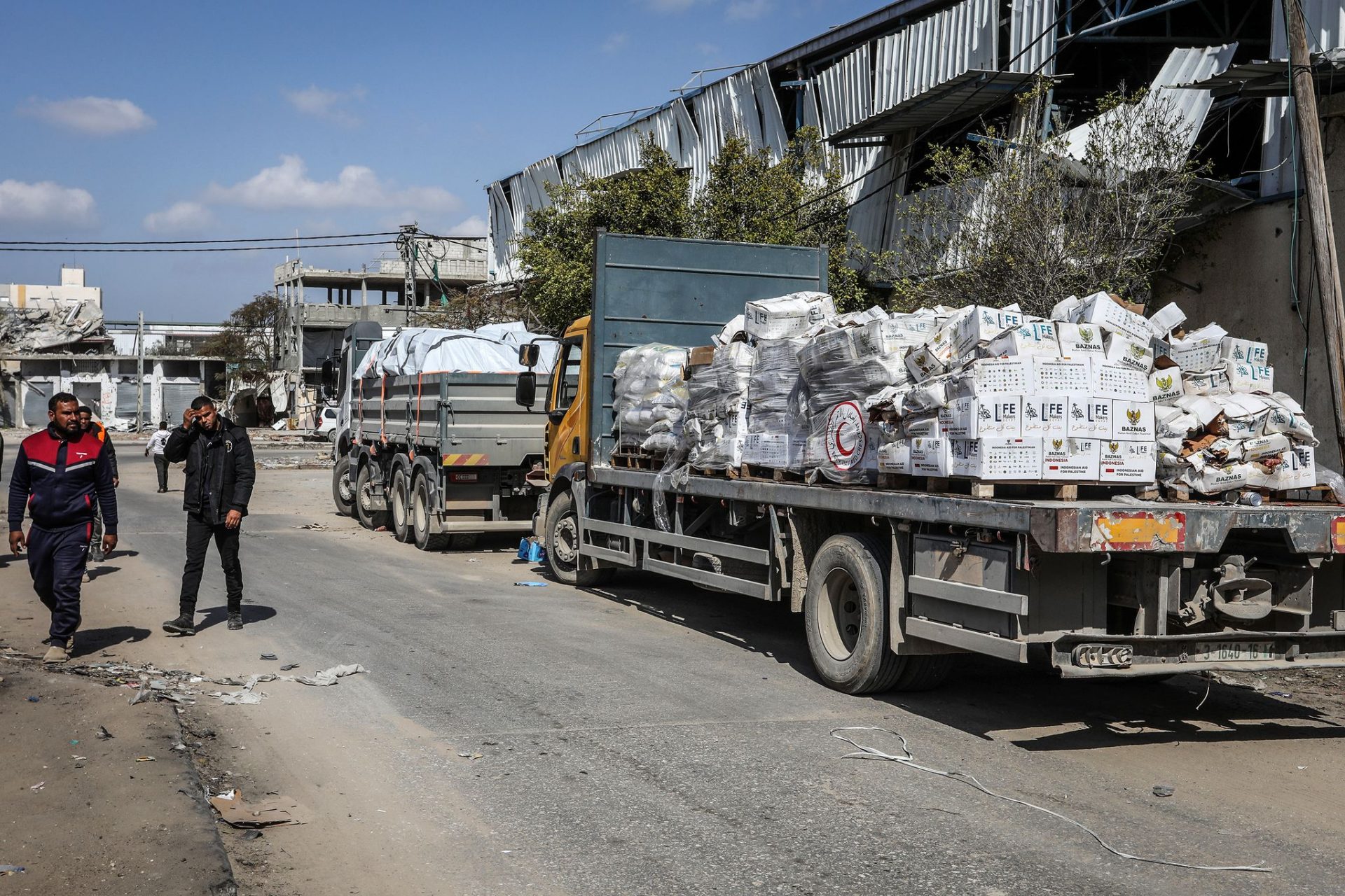 Trucks loaded with humanitarian aid cross into the Gaza Strip through the Kerem Shalom crossing.